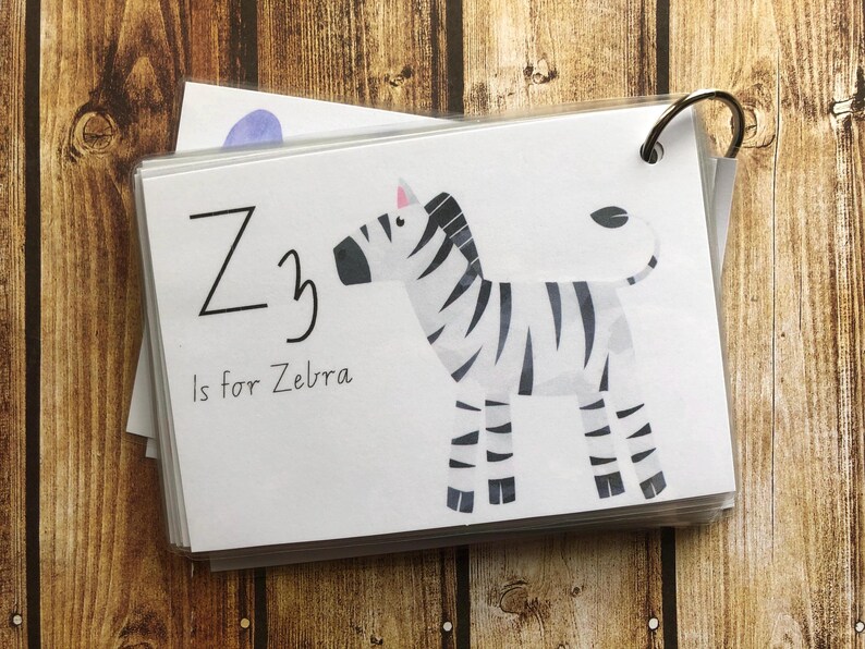 May include: A white card with black text and a black and white zebra illustration. The text reads "Z is for Zebra".