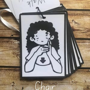 May include: Black and white illustration of a person signing the word "chair" in American Sign Language. The word "Chair" is written below the illustration.