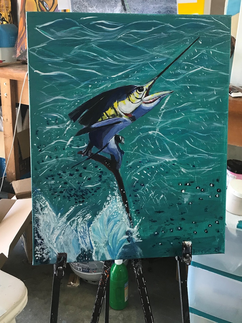 May include: Acrylic painting of a marlin leaping from teal water. The fish is depicted with blue, black, and yellow hues, with its long bill pointed upwards. White brushstrokes create the illusion of waves and splashes.