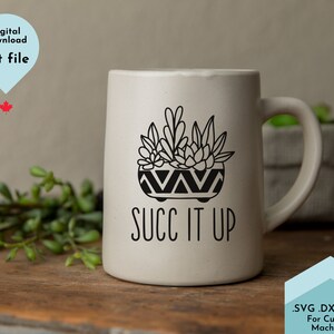 May include: White ceramic mug with a black line drawing of a potted succulent plant and the text "SUCC IT UP".