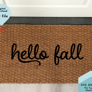 May include: A brown coir doormat with the text "hello fall" in black cursive lettering.