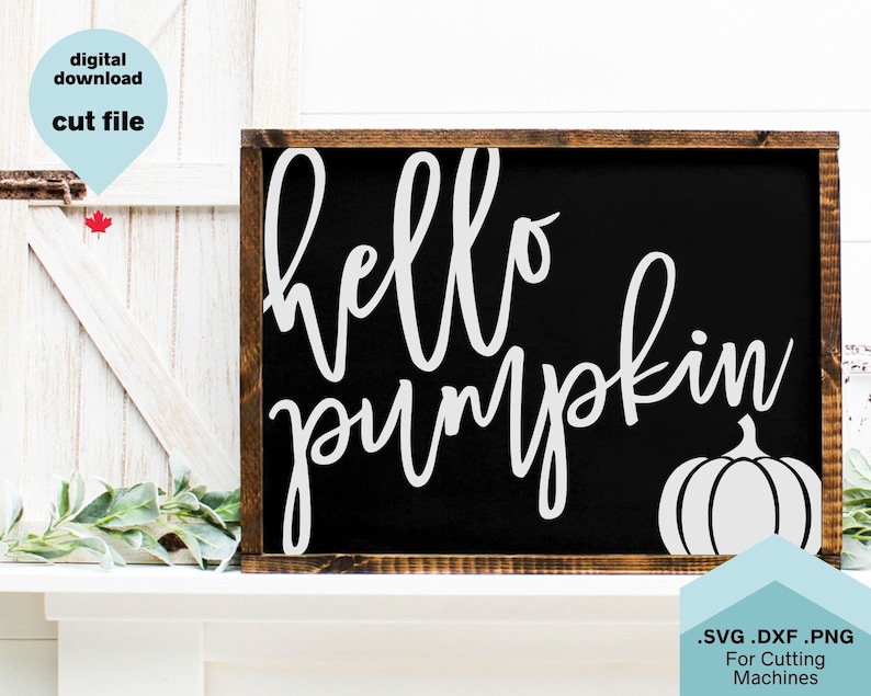 May include: A black sign with white text that reads "hello pumpkin" and a white outline of a pumpkin. The sign is in a wooden frame.