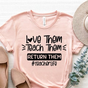 May include: A pink t-shirt with a black graphic that says "Love Them Teach Them Return Them #teacherlife".