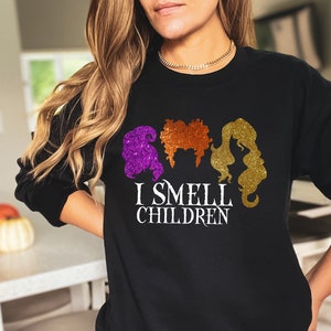 May include: Black sweatshirt with a graphic of three witches with the text "I Smell Children".