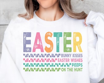 May include: White sweatshirt with a colorful "Easter" graphic and the text "Bunny Kisses, Easter Wishes, Peeps, On The Hunt".