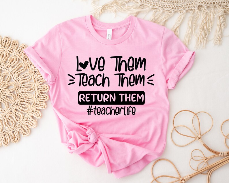May include: Pink t-shirt with black text that reads "Love Them = Teach Them = Return Them #teacherlife".