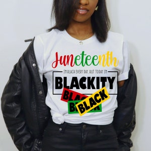May include: White t-shirt with the text "Juneteenth" in red, green, and yellow lettering. Below the text is a black rectangle with the text "I'm Black Every Day, But Today I'm Blackity" in white lettering. Overlapping the rectangle are three black rectangles with the word "Black" in red, green, and yellow lettering.