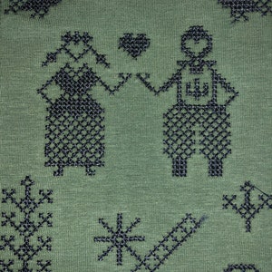 May include: Green fabric with a black embroidered design of two figures holding hands, a heart, and various other geometric shapes.