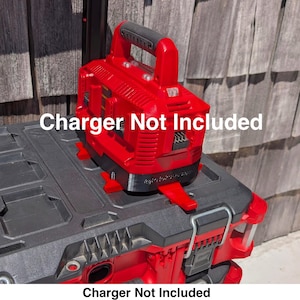 May include: A red and black tool organizer with a red power tool on top. The power tool has a black handle and the text "Charger Not Included". The organizer has a handle and a latch.
