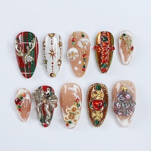 May include: Ten different Christmas-themed nail art designs. The designs include a plaid pattern with a reindeer, a star, a gingerbread man, a Christmas tree, a bow, a snowflake, a cross, and a heart.