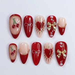 Chic Dark Red Press-On Nails: Adorned with Gold Bows, Charming Cherries & Sparkling Gems – Perfect Holiday Glam or Thoughtful Gift for Her