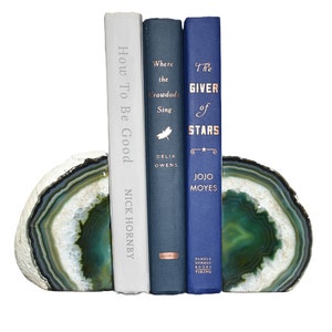 May include: Green agate bookends with three books, "How To Be Good" by Nick Hornby, "Where the Crawdads Sing" by Delia Owens, and "The Giver of Stars" by Jojo Moyes.
