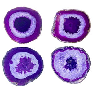 May include: Set of four purple agate coasters with a white center and a natural, polished finish. Each coaster is approximately 4 inches in diameter.