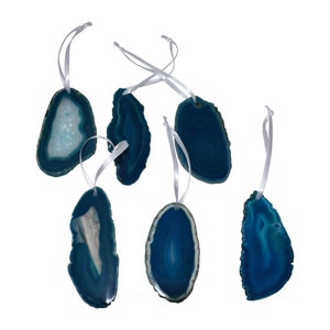 May include: Set of six teal blue agate slice ornaments with white ribbon hangers. Each slice has a unique pattern of natural agate.
