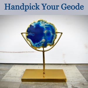 May include: A blue and gold agate geode on a gold metal stand. Handpick Your Geode.