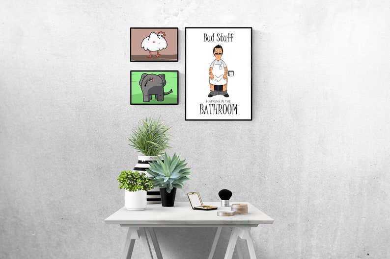May include: Three framed illustrations on a white wall. The top illustration is a brown background with a white chicken. The middle illustration is a green background with a gray elephant. The bottom illustration is a white background with a cartoon man in a white apron and the text "Bad Stuff Happens in the Bathroom".