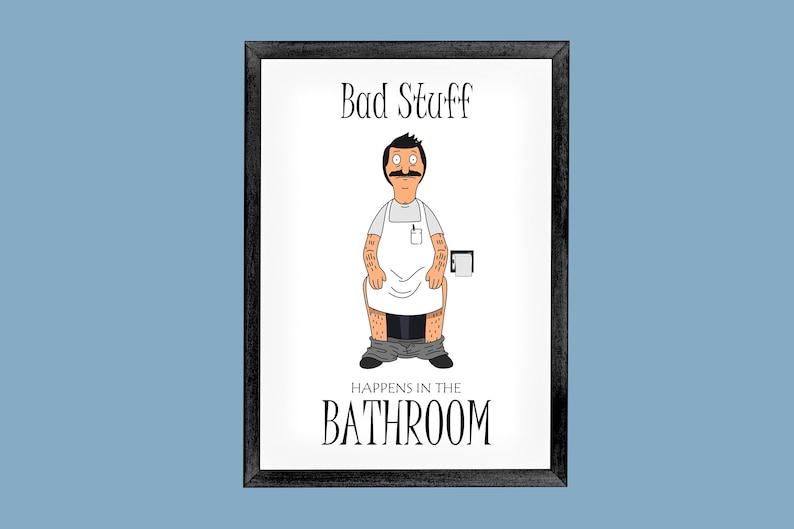 May include: A white framed print with a cartoon illustration of a man in a white shirt and grey pants sitting on a toilet. The text on the print reads "Bad Stuff Happens in the Bathroom".
