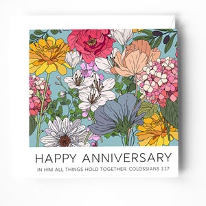 May include: An anniversary card with a colourful floral design. The card features a variety of flowers in yellow, pink, white, and blue. The text "HAPPY ANNIVERSARY" is displayed, along with a Bible verse. The background is light blue.