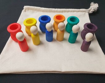 wooden peg dolls in cups