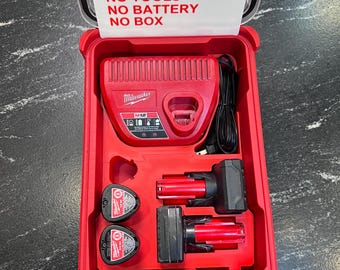 May include: Red Milwaukee M12 battery charger and batteries in a red case. The case lid has a white sign that reads "INSERT ONLY, NO TOOLS, NO BATTERY, NO BOX". The case contains a charger, two batteries, and two battery-powered tools.