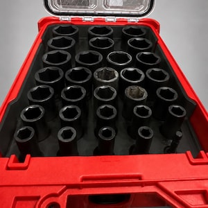 May include: A red plastic tool case insert with a black foam organizer containing multiple circular cutouts for sockets. The insert features a clear hinged lid with a honeycomb pattern. Text at the bottom reads: INSERT ONLY — NO TOOLS • NO BATTERY • NO BOX.