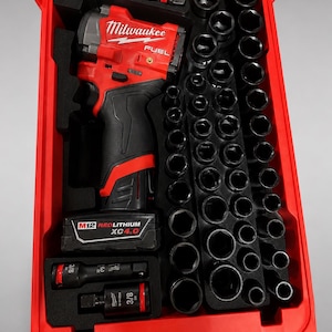 May include: A red plastic tool case insert with custom-moulded compartments containing a Milwaukee Fuel cordless impact wrench, a M12 Redlithium XC4.0 battery, two 3/8 inch drive extensions, and a large collection of black metal impact sockets.