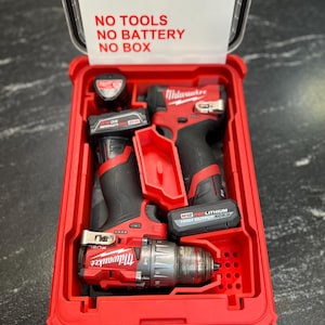 Könnte beinhalten: Rote Milwaukee Elektrowerkzeuge in einem roten Koffer. Der Koffer ist geöffnet und zeigt einen Bohrer, einen Schlagschrauber und Batterien. Der Text "INSERT ONLY" ist auf dem Kofferdeckel zu sehen. Die Werkzeuge sind schwarz und rot.