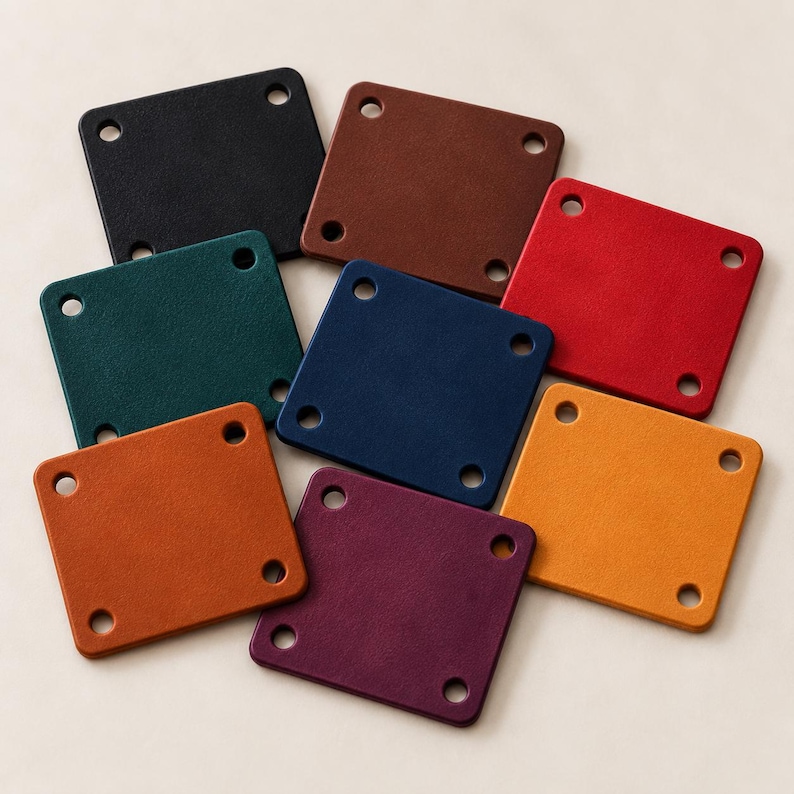 May include: A collection of eight square leather patches in various colors including black, brown, red, dark green, navy blue, orange, yellow, and purple. Each patch features rounded corners and four pre-punched circular holes at the corners.