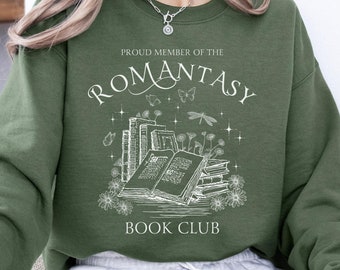 May include: Military green sweatshirt with white text reading "PROUD MEMBER OF THE ROMANTASY BOOK CLUB". The design includes an open book, stacks of books, flowers, butterflies, and a dragonfly.