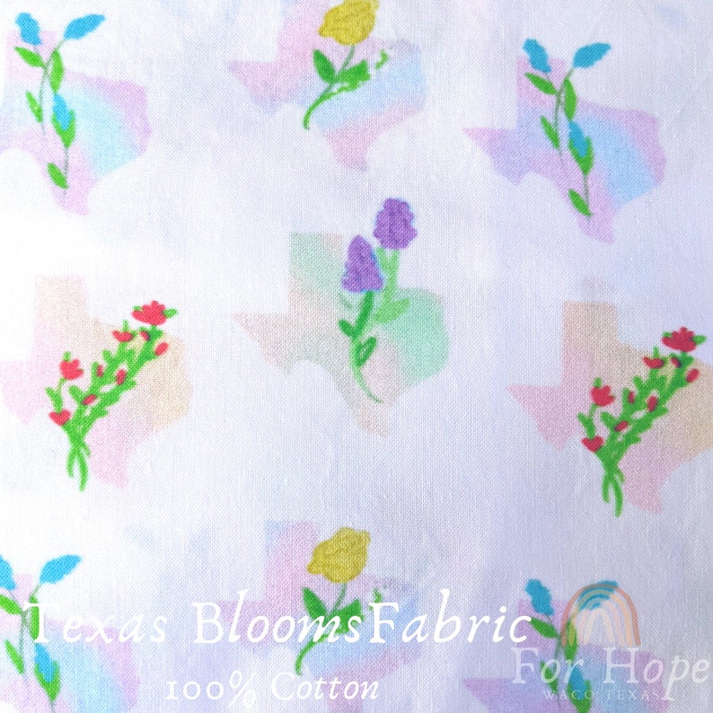 May include: White fabric with a repeating pattern of colorful flower bouquets inside the outline of the state of Texas. The fabric has the text "Texas Blooms Fabric For Hope Waco Texas 100% Cotton" printed at the bottom.