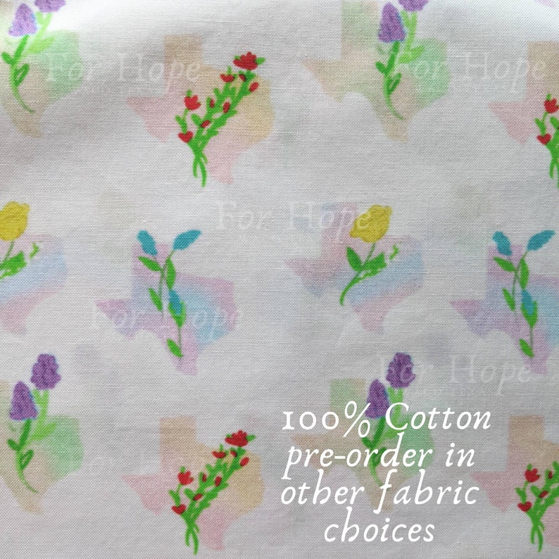 May include: White fabric with a repeating pattern of colorful flowers and the state of Texas. The text "For Hope" is repeated throughout the fabric. The text "100% Cotton pre-order in other fabric choices" is also visible.