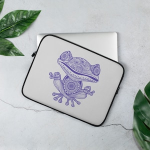 May include: Purple mandala frog design laptop sleeve. The frog is sitting in a meditative pose with its eyes closed.