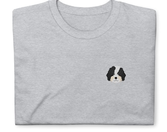 May include: A gray t-shirt with an embroidered image of a black and white dog's face.