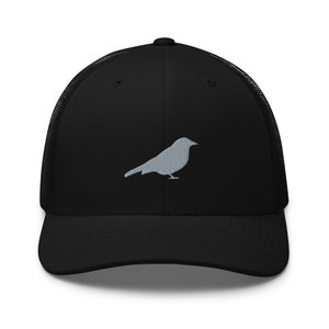 May include: A black mesh trucker hat with a gray embroidered silhouette of a bird on the front.