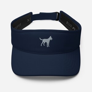 May include: A navy blue visor with a gray embroidered silhouette of a dog. The visor has a black adjustable strap with the text "110 FIT" on it.