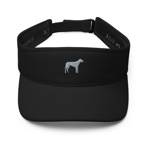 May include: Black visor with a grey embroidered dog silhouette. The visor has a black adjustable strap with the text "110 FIT" on it.