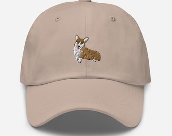 May include: A beige baseball cap with an embroidered image of a brown and white corgi dog.