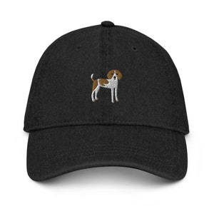 May include: A black denim baseball cap with an embroidered brown and white dog on the front.