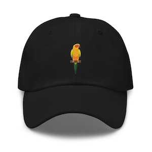 May include: A black baseball cap with an embroidered image of a yellow and orange sun conure parrot.