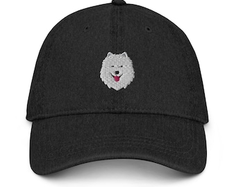 May include: A black denim baseball cap with an embroidered white dog face with a pink tongue.