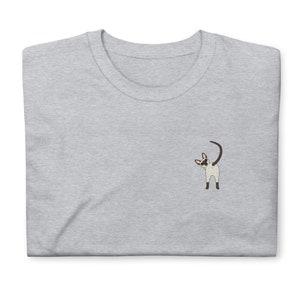 May include: A gray t-shirt with a small embroidered image of a Siamese cat looking over its shoulder.