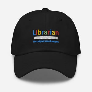 May include: Black baseball cap with the text "Librarian" in rainbow colors and the text "The original search engine" in white below.