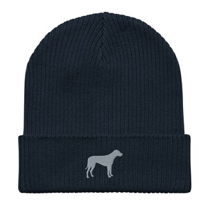 May include: A dark blue knitted beanie with a gray embroidered silhouette of a dog on the front.