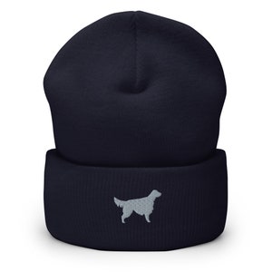 May include: A navy blue beanie with a gray embroidered silhouette of a dog on the front.