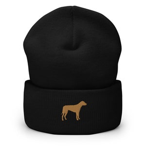 May include: Black beanie with a brown embroidered dog silhouette.