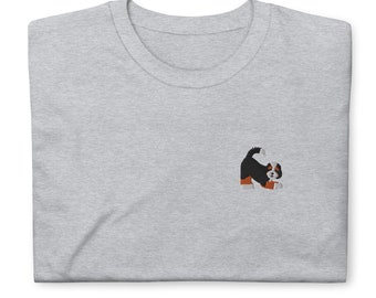 May include: A gray t-shirt with an embroidered image of a Bernese Mountain Dog puppy. The puppy is black, white, and brown with a playful expression.