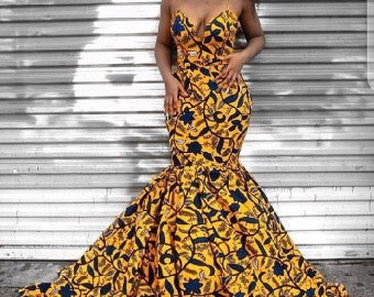 May include: A yellow and blue patterned mermaid-style dress with a plunging neckline.