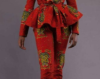 May include: A red and green patterned pantsuit with a ruffled top and a matching belt. The pantsuit has a fitted silhouette and a long-sleeved top.