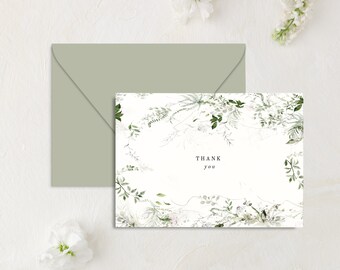 May include: A white card with a green leafy floral design and the text "THANK you" in the center.