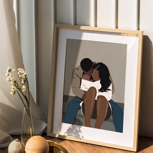 May include: A framed illustration of a couple embracing. The man is wearing a brown jacket and blue jeans. The woman is wearing a white top and has long black hair. The background is a light gray color.